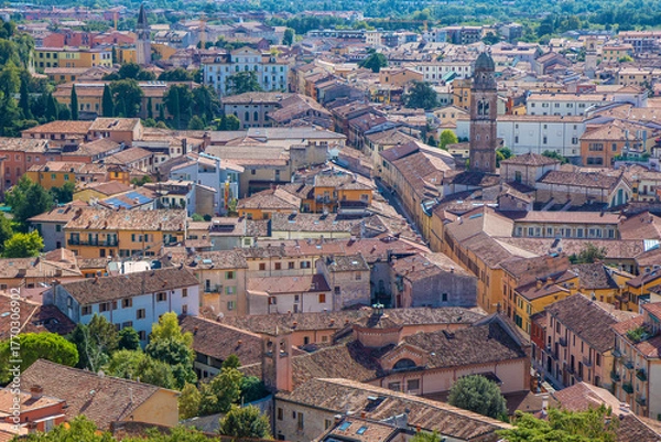 Fototapeta Panoramic aerial view of Verona, the city of love in Veneto, Italy, showing the Arena, red-tiled roofs, medieval streets, and the Adige River winding through the historic cityscape