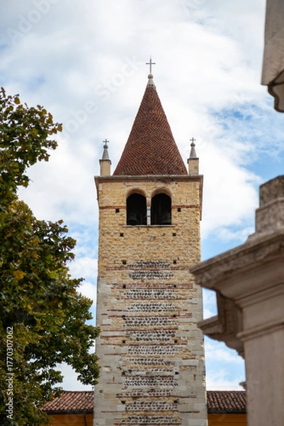 Obraz Bell tower of the Santi Apostoli church in Verona, Italy - a historic structure rising above the city with classic stone architecture and a prominent tower visible from surrounding streets