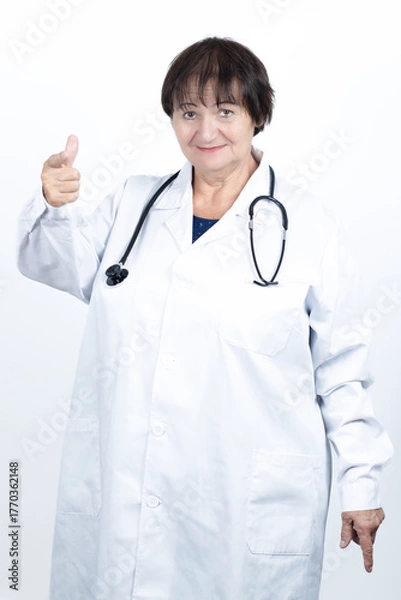 Obraz Senior female doctor pointing and gesturing down