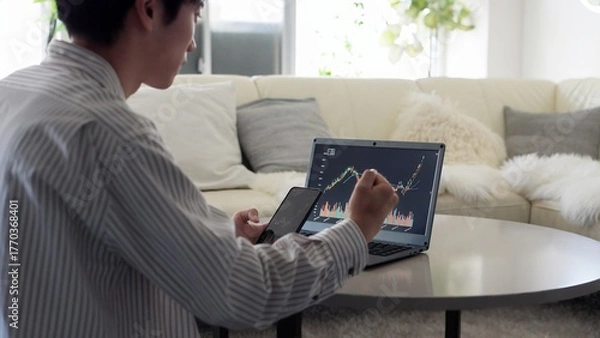 Obraz 株価の上昇を見て喜ぶアジア人男性