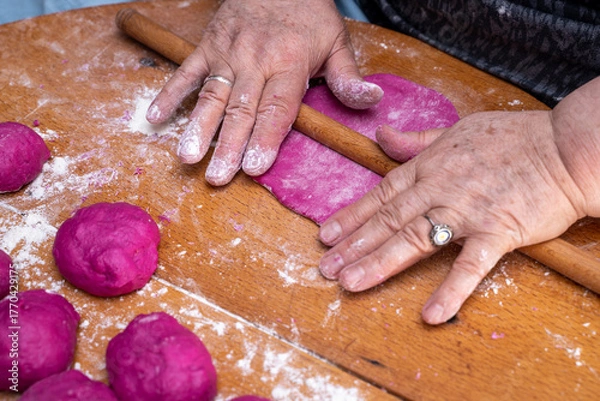 Fototapeta Woman hands making pastry. Colored bread dough making process.
