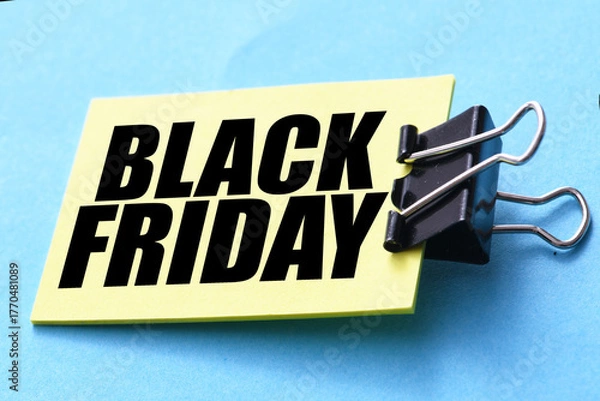 Fototapeta Black Friday words written on a piece of paper. Time for promotions and sales in stores.