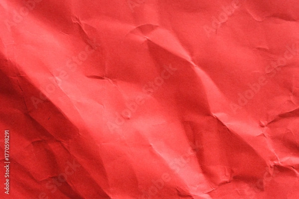Fototapeta Full frame abstract background of crumpled dark red paper texture with diagonal folds and creases. Represents stress, anger, emotion, abstract surface, grunge, and dramatic concept.