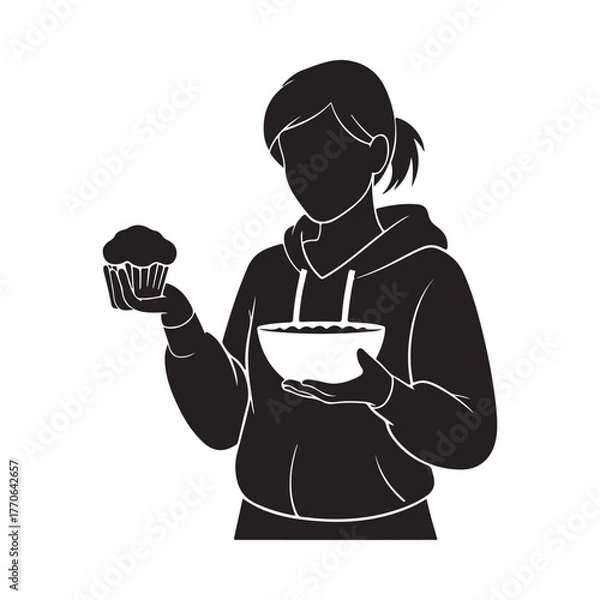 Fototapeta Silhouette of a person holding a cupcake and a bowl of batter