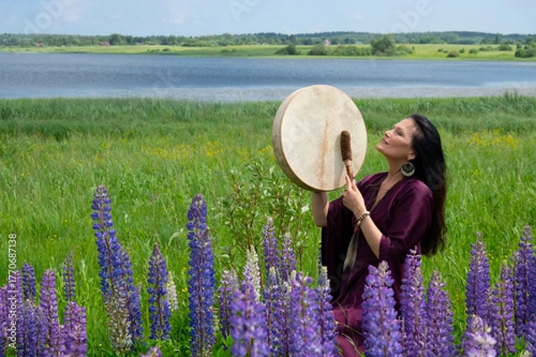 Fototapeta Female shaman drumming among the flowers