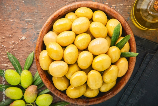 Obraz Whole Natural green olives in wooden bowl. It's healthy Mediterranean snack.