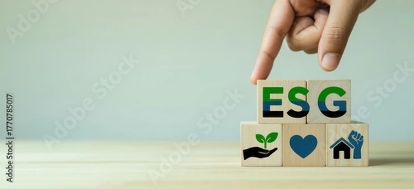 Fototapeta ESG Concept Illustration: A hand carefully positions wooden blocks spelling ESG, a visual representation of environmental, social, and governance principles, with corresponding icons.