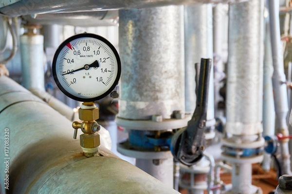 Obraz Manometer on the hot water pipeline in the boiler room.