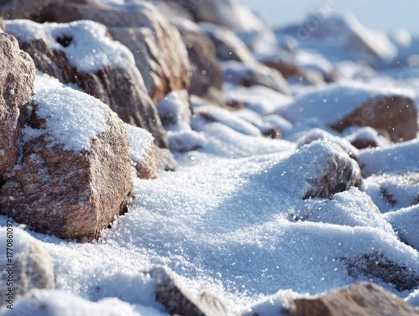 Fototapeta Shimmering Close-Up of Freshly Fallen Snow Covering Rocks with Sparkling Ice Crystals Under Bright Sunlight