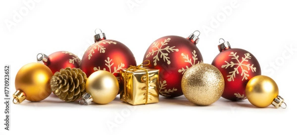 Fototapeta Festive Christmas ornaments and a gift arranged on a white background perfect for holiday promotions