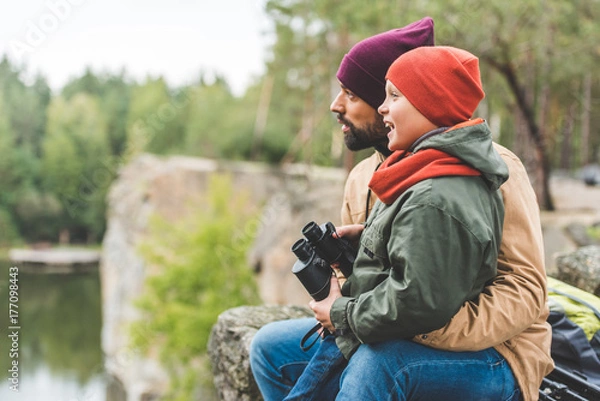 Fototapeta family with binoculars in forest
