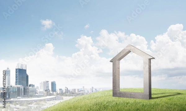 Fototapeta Conceptual image of concrete home sign on hill and natural landscape at background