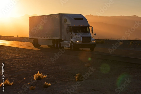 Obraz American style truck on freeway pulling load. Transportation theme