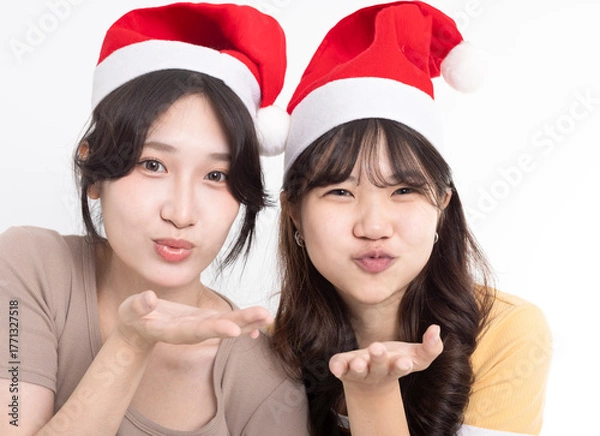 Fototapeta Girls in Santa's caps having fun