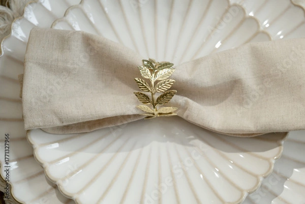 Obraz White plates decorated napkin and golden ring. Top view. Elegant crockery.