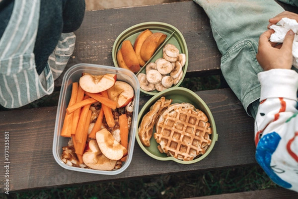 Fototapeta Healthy Kids Lunch Box Outdoors. Food snacks for children on the street.