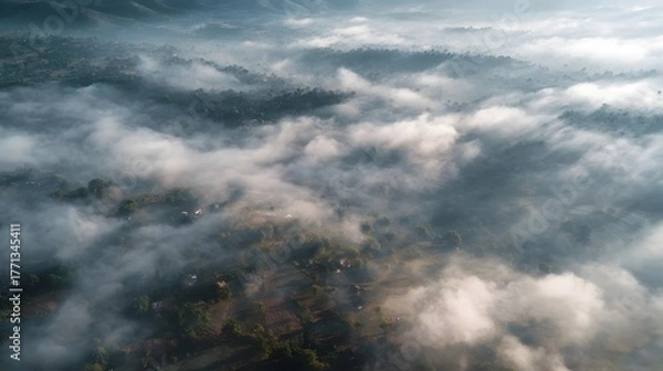 Obraz Aerial view of misty mountains and clouds at sunrise.