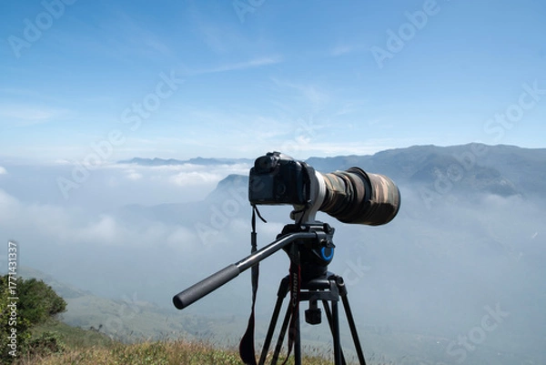 Obraz camera on tripod against sky