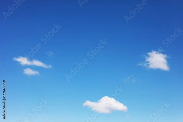 Fototapeta Blue sky background and white clouds soft focus, and copy space horizontal shape.