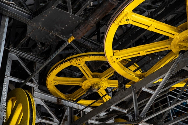Obraz Lift technology: old metal structures and yellow drive wheels, mechanism