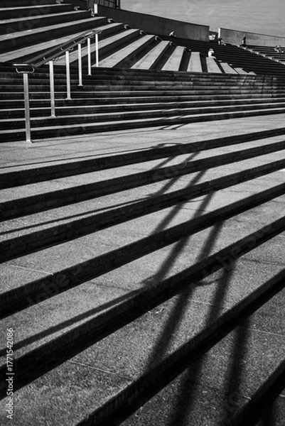 Fototapeta Modern Concrete Staircase with Metal Railings and Geometric Shadows