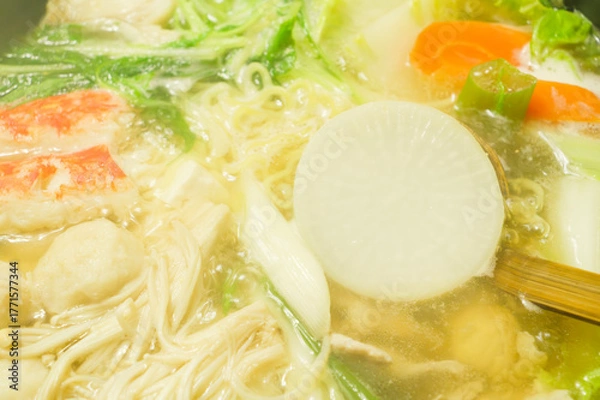 Fototapeta A hot pot dish simmered with vegetables like green onions, daikon radish, and carrots, along with crab and chicken—a famous winter delicacy in Japan.