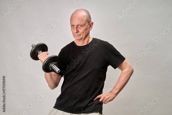 Obraz Old man in sportwear practice some exercice with dumbbell