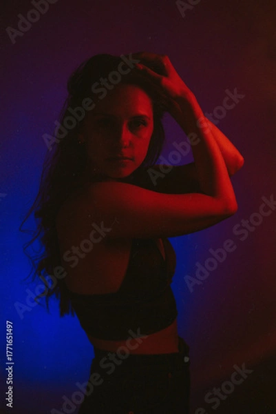 Obraz Moody Neon Portrait of Woman with Creative Lighting and Motion Blur