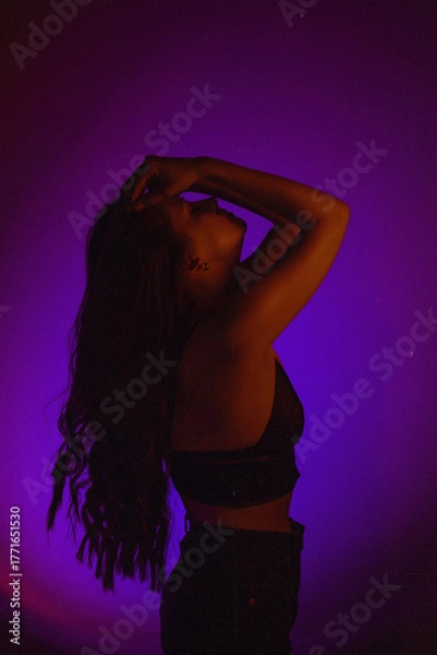 Obraz Moody Neon Portrait of Woman with Creative Lighting and Motion Blur