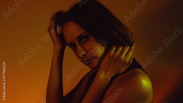 Obraz Moody Neon Portrait of Woman with Creative Lighting and Motion Blur