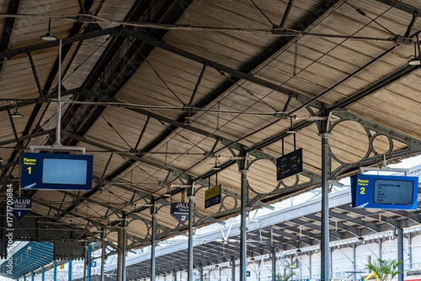 Fototapeta Modern Train Station Platforms with Steel Roof and Digital Information Boards