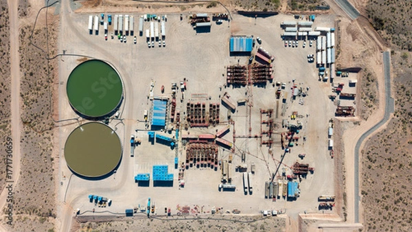 Fototapeta Aerial view of unconventional oil and gas extraction (shale oil) in Añelo, Neuquén. Fracking equipment. Overhead view
