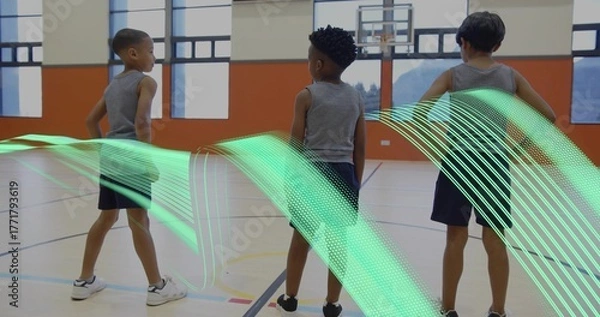 Fototapeta Standing three boys in athletic wear facing basketball hoop on court, with green ribbon graphic