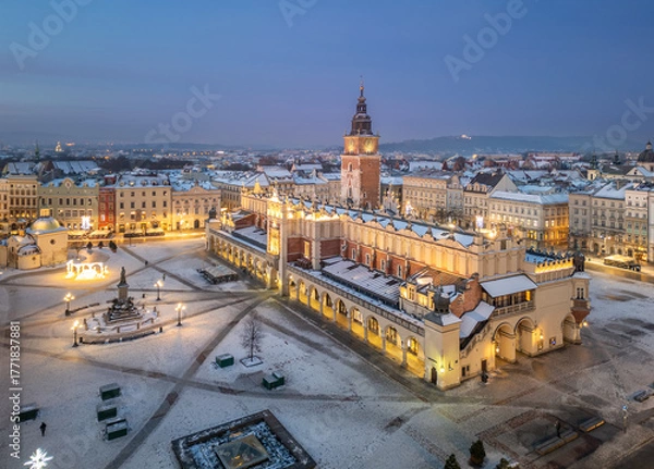 Fototapeta Aerial late night / dawn view of snow covered Main Square with Cloth Hall and Town Hall Tower in Krakow, Poland