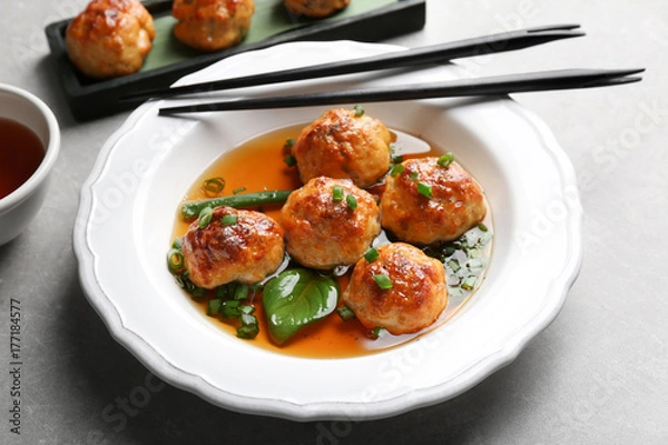 Obraz Delicious meatballs with sauce in plate on table