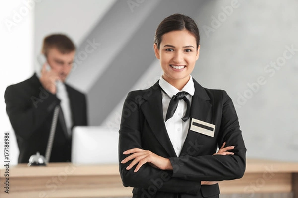 Fototapeta Female hotel receptionist at workplace