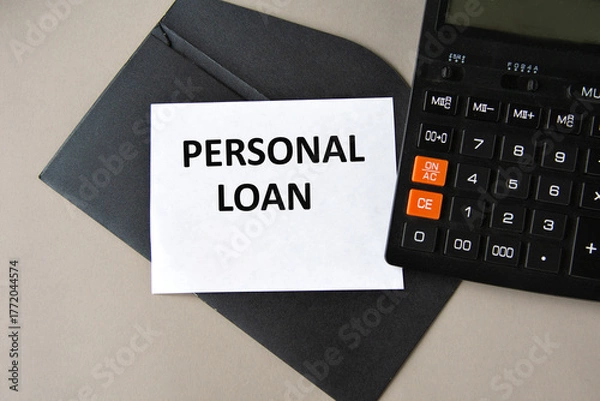 Fototapeta PERSONAL LOAN - words on white sheet on black envelope with calculator
