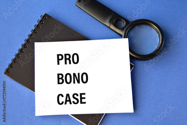 Fototapeta PRO BONO CASE - words on a white sheet on a black notebook with a magnifying glass