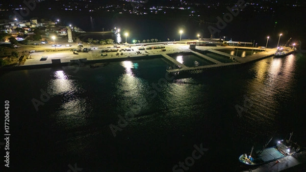 Obraz The atmosphere of Waingapu's Old Town to the Seaport seen from the air with a drone at night