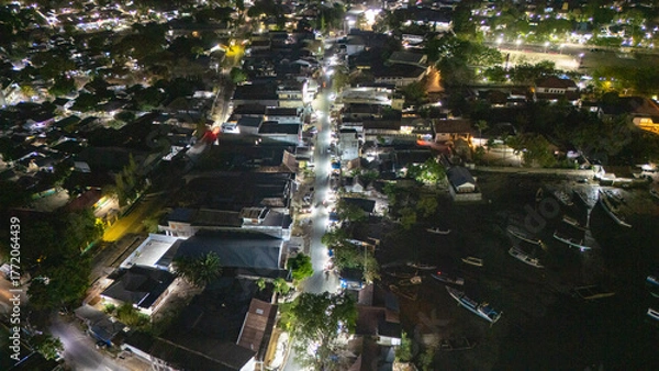 Obraz The atmosphere of Waingapu's Old Town to the Seaport seen from the air with a drone at night