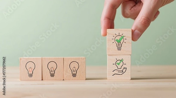 Fototapeta Creativity, innovation. Symbolizing the chosen or best idea. A person’s hand is placing the top block to complete the picture. Professional and motivational.