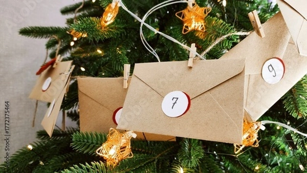 Fototapeta Preparing an Advent calendar for Christmas. Eco-craft envelopes with numbers for children. Christmas background, Advent from small craft envelopes.