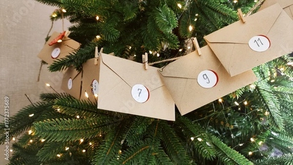 Fototapeta Preparing an Advent calendar for Christmas. Eco-craft envelopes with numbers for children. Christmas background, Advent from small craft envelopes.