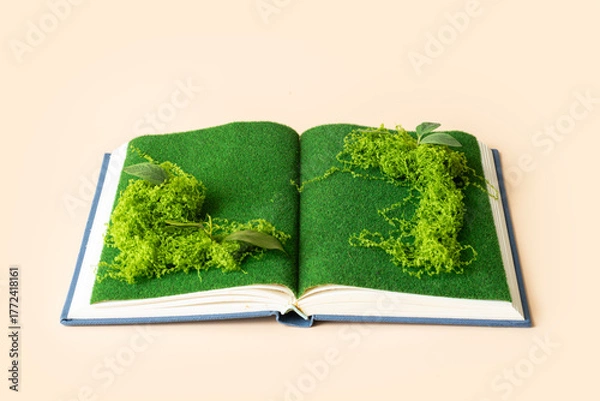 Obraz Open page with with plants and moss growing. Plain background. Conceptual sustainable lifestyle still life. 

