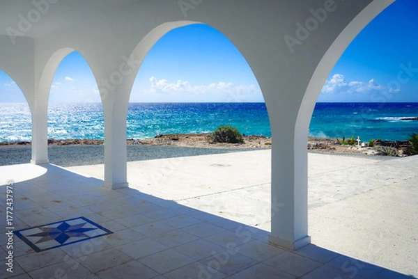 Fototapeta View of the sea and the coast from the arches of a greek chapel