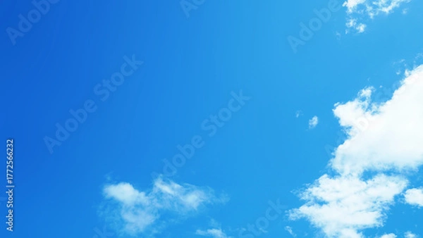 Fototapeta Clear blue sky with soft white clouds on a bright sunny day