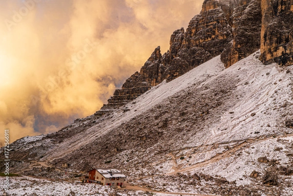 Fototapeta The beautiful snow-capped Dolomite Mountains around Tre Cime and Cadini di Misurina - captured at sunrise and sunset in gorgeous light.