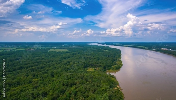 Fototapeta Aerial view of a river flowing through lush green forests and a harbor, highlighting natural beauty and accessibility
