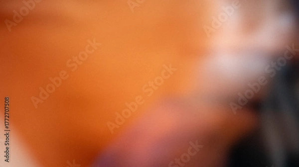 Obraz Grainy warm abstract blurred background in orange and brown tones. Soft gradient texture with light and shadow for creative design, photography, or backdrop.