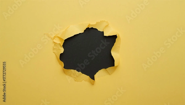 Fototapeta Torn yellow paper reveals a dark mysterious space creative concept